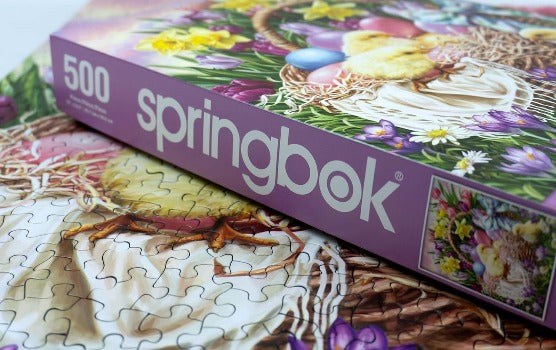 Springbok Basket Full of Spring 500 Piece Jigsaw Puzzle for Adults and Kids Celebrating Easter with a Spring Backdrop and a Basketful of Baby Chicks and Colorful Eggs on Display